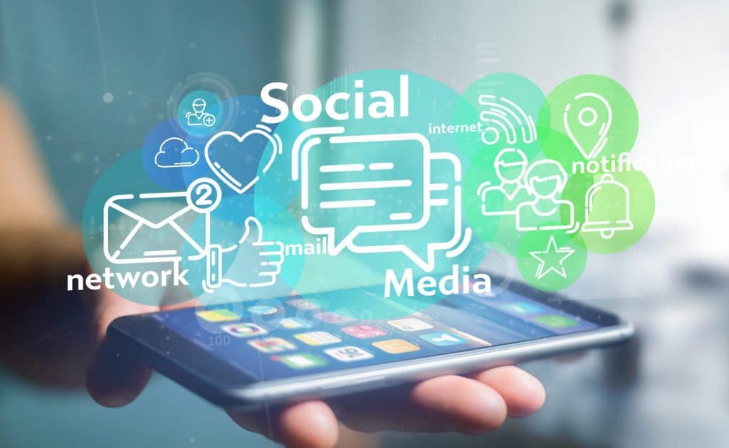 Social media graphic depicting man holding an ipad and social media icons coming out of it for the webinar How To Set Up Your Social Media Content Strategy & Plan For 2022